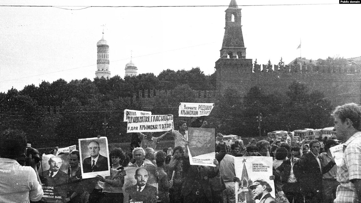 Crimean Tatar demonstration in the Soviet capital city of Moscow in July 1987. The people are holding official Soviet propaganda placards featuring Vladimir Lenin and Mikhail Gorbachev, and makeshift signs reading, “Democracy, Glasnost for Crimean Tatars as well!” “Return the homeland to Crimean Tatars.” Source. ~