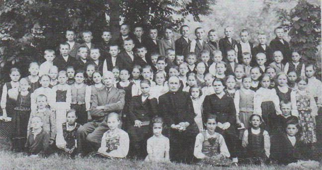 Pupils and teachers of Poliany school, early 1940s. Almost all of them were deported the following years. Photo from the book My village Poliany ~