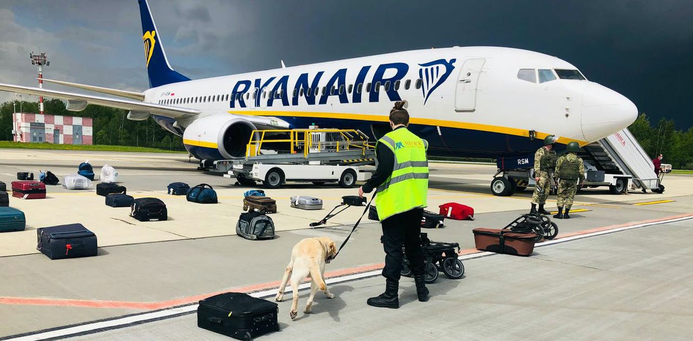 Belarusian security personnel conducts a search of the Ryanair flight from which they took dissident journalist Roman Protasevich. Photo: people.onliner.by ~