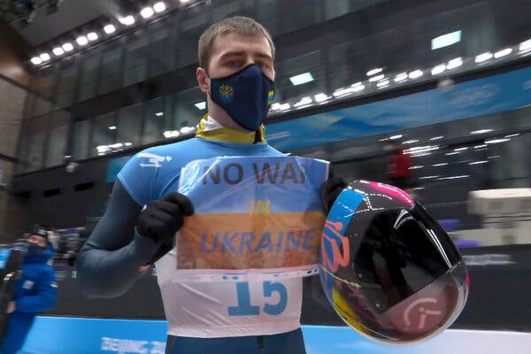 A Ukrainian skeleton athlete flashed a small sign that read "No War in Ukraine" to the cameras as he finished a run at the Beijing Olympics on Friday night.