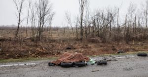 Dead civilians are seen near a highway 20 km outside of Kyiv. Under the blanket are 4-5 dead naked women whom Russian soldiers tried to burn right there on the side of the road. Photo by Mikhail Palinchak. Source: Ministry of Defense of Ukraine. 2 April 2022