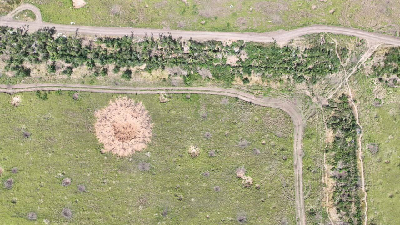 Russian artillery destroys Ukrainian fields scars of war