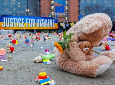 teddy bear and candles on the demonstration for the safe return of deported to Russia Ukrainian children