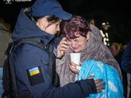A Ukrainian rescuer is supporting a woman affected by the Russian attack in Odesa oblast