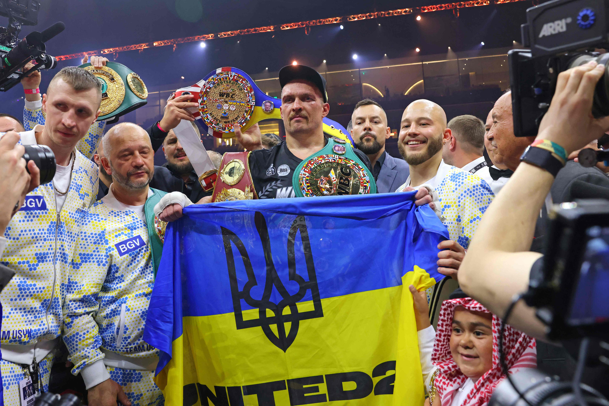 Ukraine's Oleksandr Usyk (C) celebrates his victory over Britain's Tyson Fury during a heavyweight boxing world championship fight at Kingdom Arena in Riyadh, Saudi Arabia on May 19, 2024