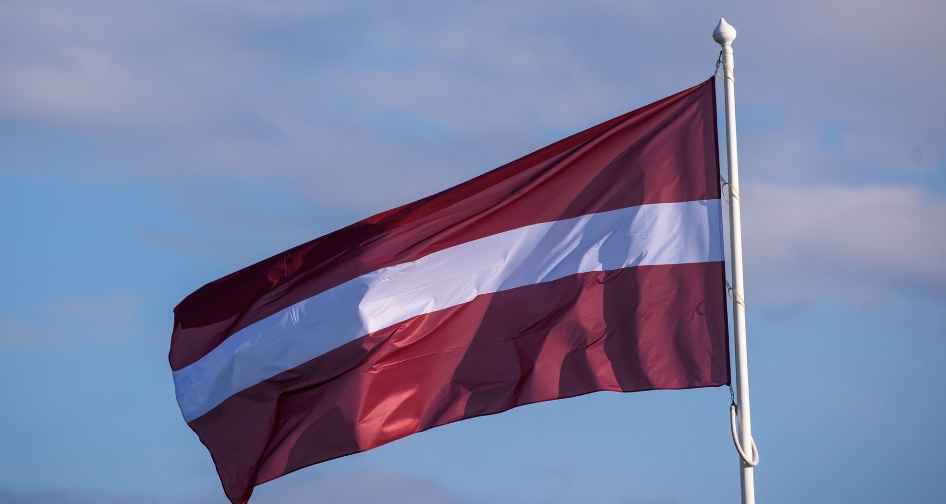 Latvian flag, illustrative image. Photo via Eastnews.ua.