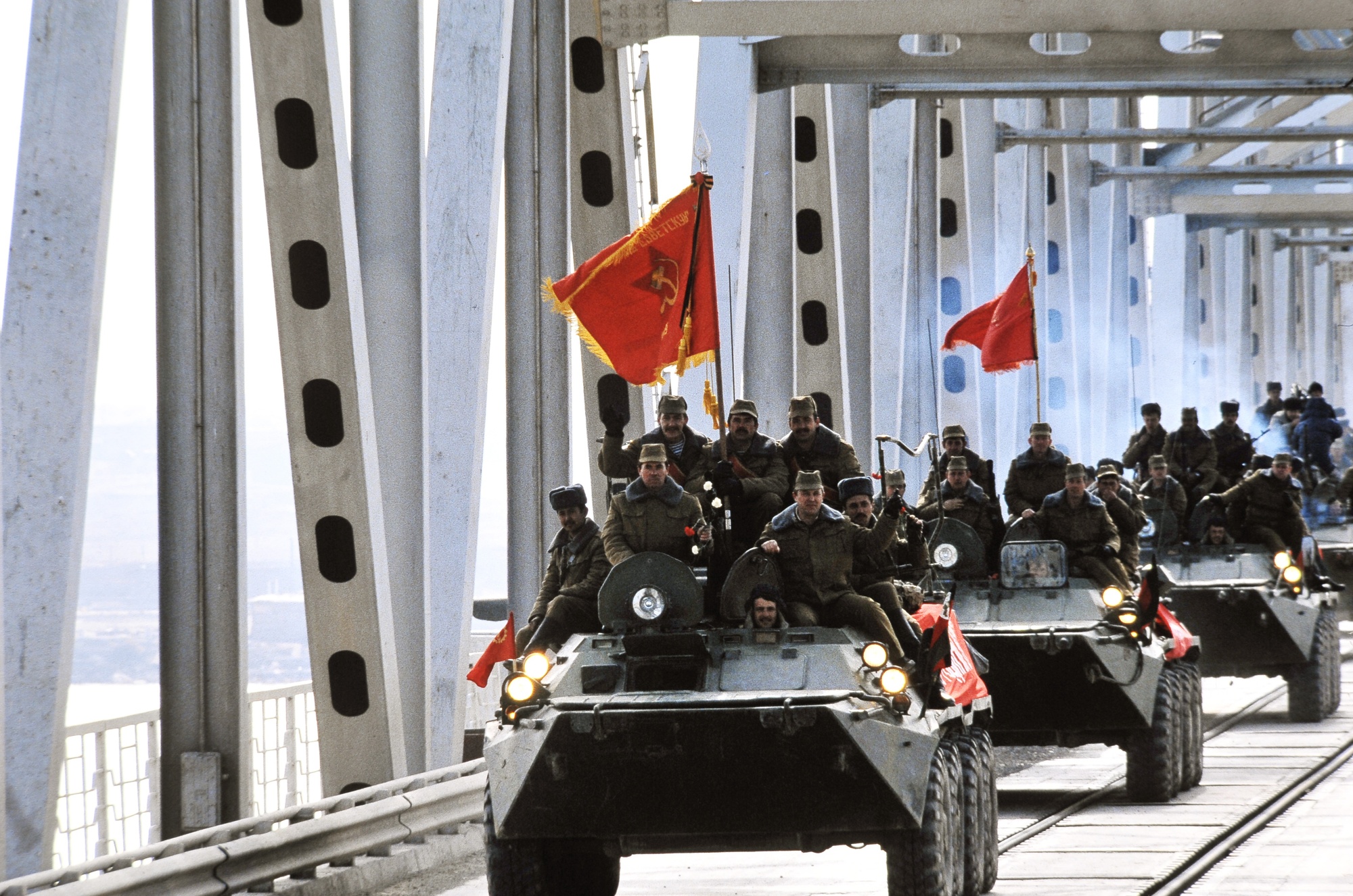 A Red Army convoy crosses the Soviet-Afghan Friendship Bridge on Amu Darya river in February 1989 in Hairatan, Afghanistan. The convoy was the the last phase of the 9-month-long Soviet withdrawal from Afghanistan. It ended the Soviet-Afghan War, which lasted 9 years (1979–1989). Photo via Eastnews.ua.