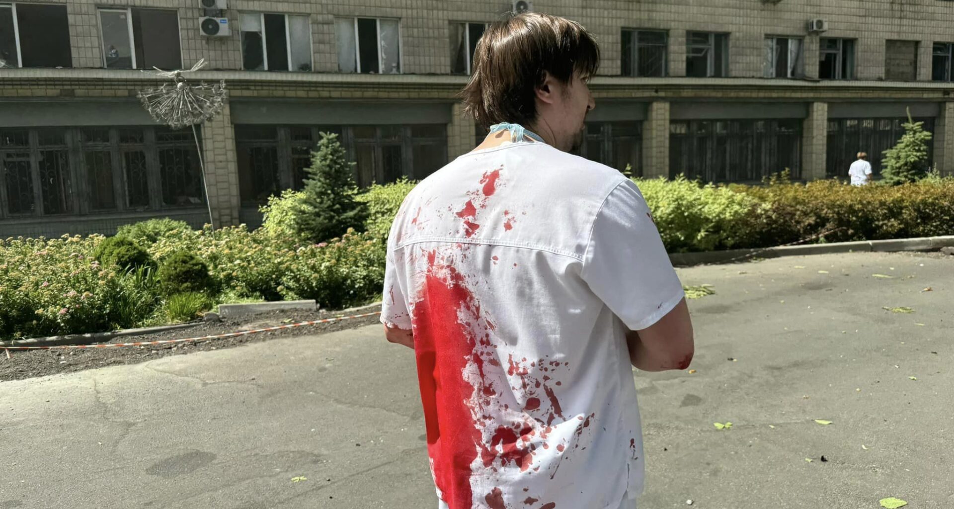 A Ukrainian doctor of the Okhmatdyt Children's Hospital covered in blood after the Russian attack.