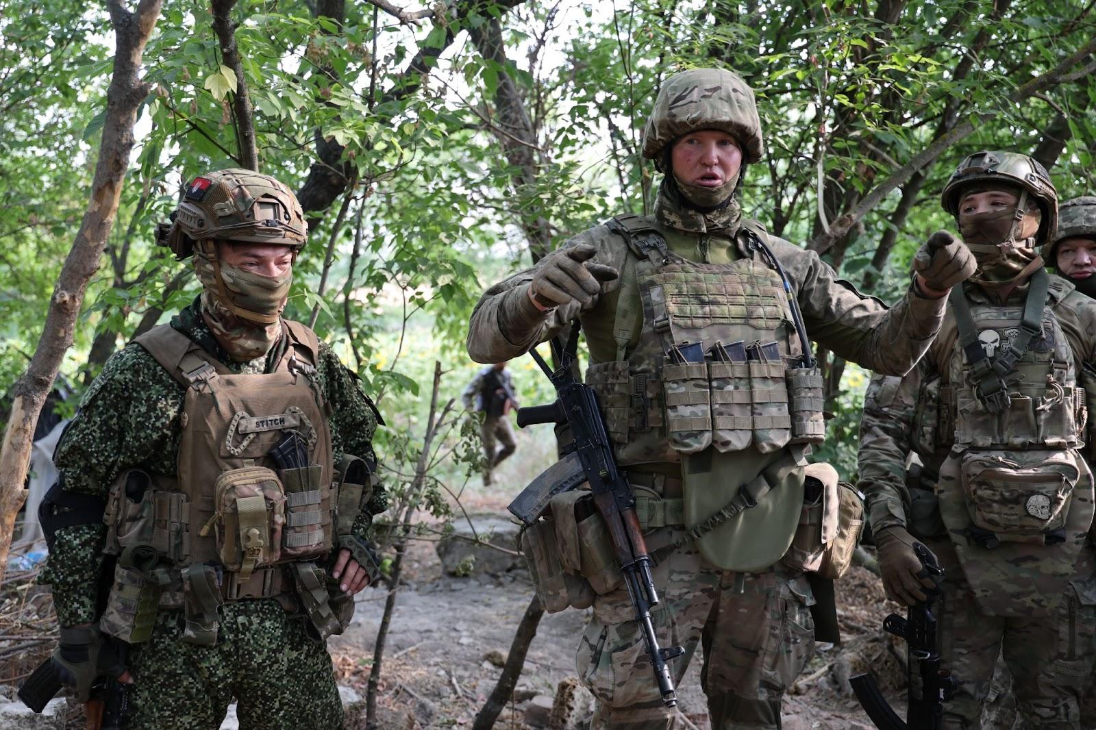 A Colombian soldier who goes by the callsign "Stitch" listens to instructions from the company commander "Passport" of the 98th Separate Territorial Defense Battalion.  Source: David Kirichenko