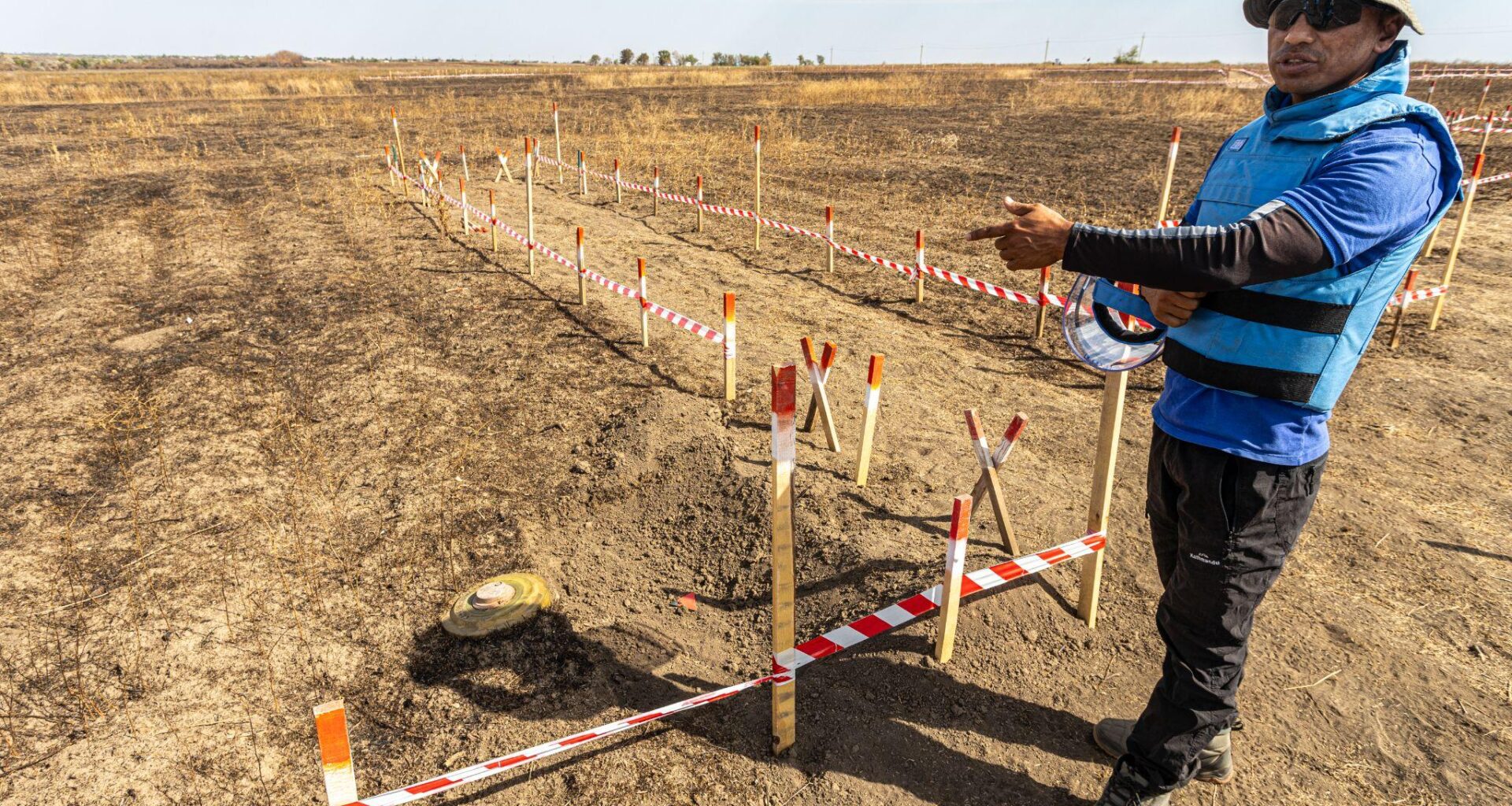 A team leader shows a TM-62 anti-tank mine in a contaminated area. Demining in Ukraine during the full-scale Russian invasion