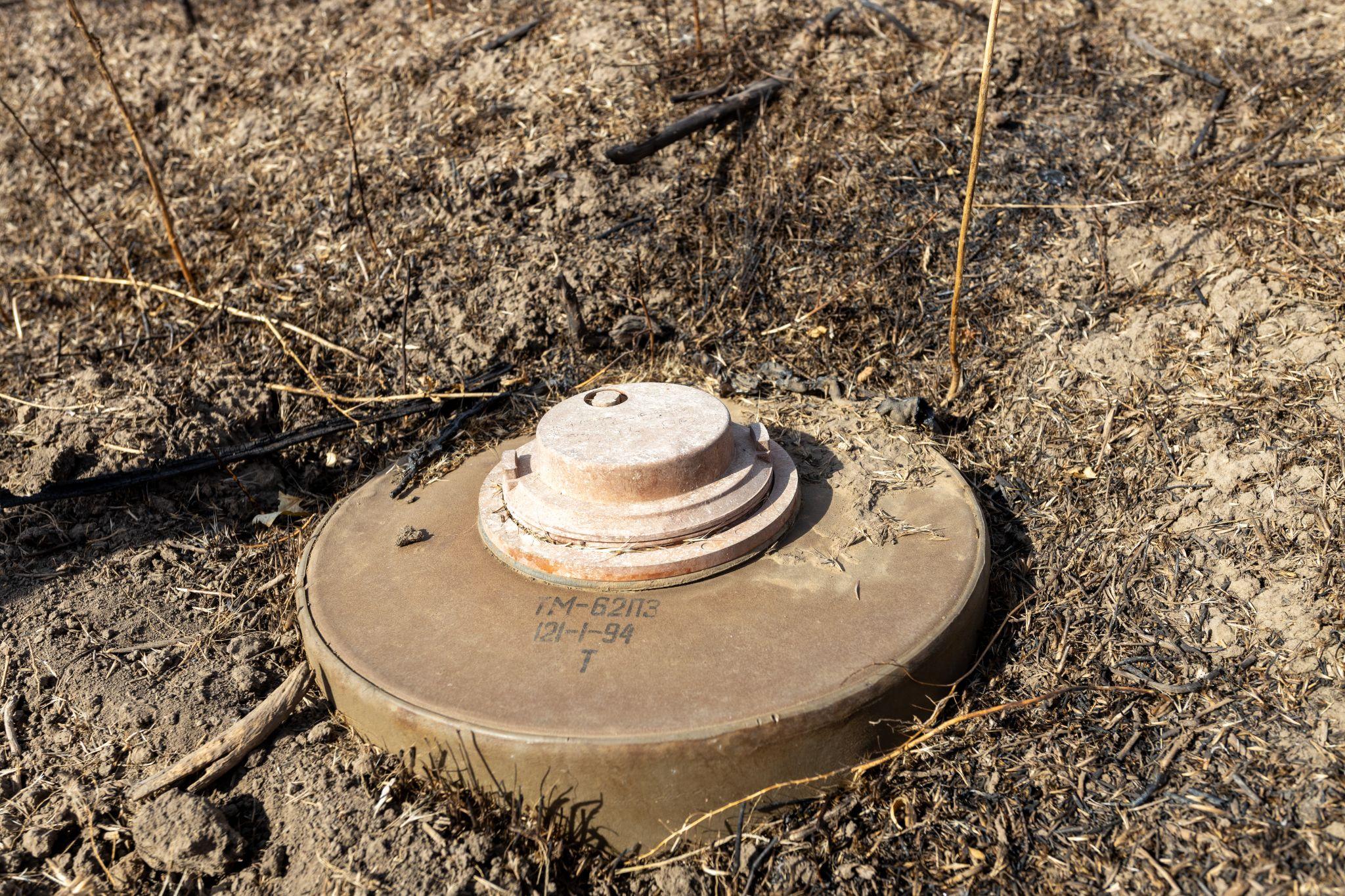 A TM-62 mine half-buried in the liberated Maksymivka, Mykolaiv Oblast of Ukraine. Demining in Ukraine during the full-scale Russian invasion