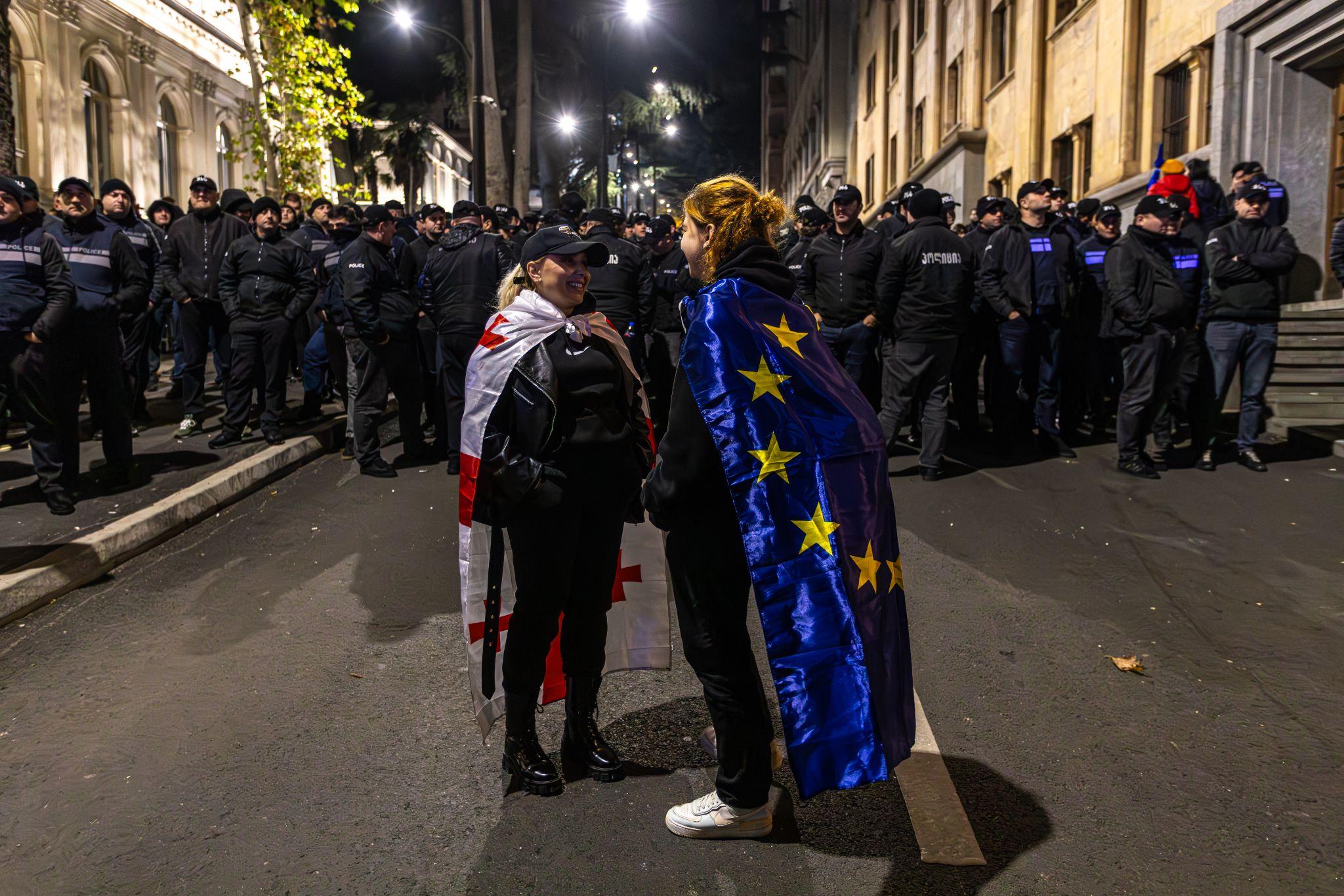 Demonstrators talking on Rustaveli Avenue under heavy police surveillance after Georgia's controversial 26 October parlimentary elections where Georgian Dream has claimed a win Salome Zurabishvili. (Théo Prouvost)