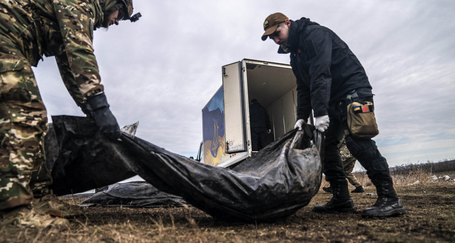 DONETSK OBLAST, UKRAINE - FEBRUARY 24: Volunteers of a group called Black Tulip prepare to examine personal belongings of two Russian soldiers whose bodies were collected on the second anniversary of Russia-Ukraine war in Donetsk Oblast, Ukraine on February 24, 2024.