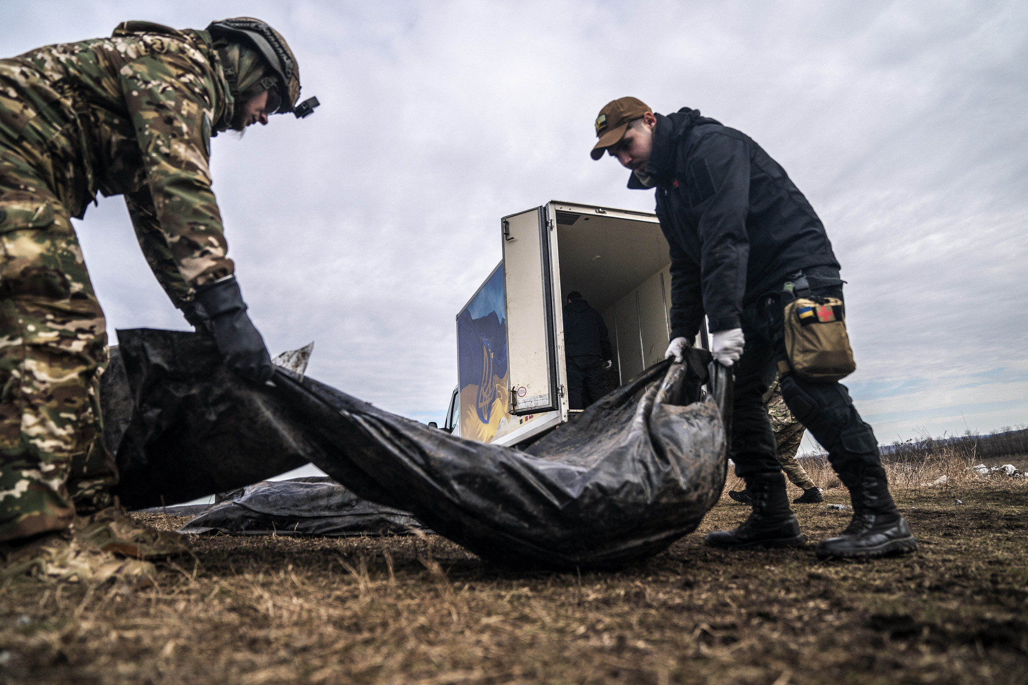 DONETSK OBLAST, UKRAINE - FEBRUARY 24: Volunteers of a group called Black Tulip prepare to examine personal belongings of two Russian soldiers whose bodies were collected on the second anniversary of Russia-Ukraine war in Donetsk Oblast, Ukraine on February 24, 2024.