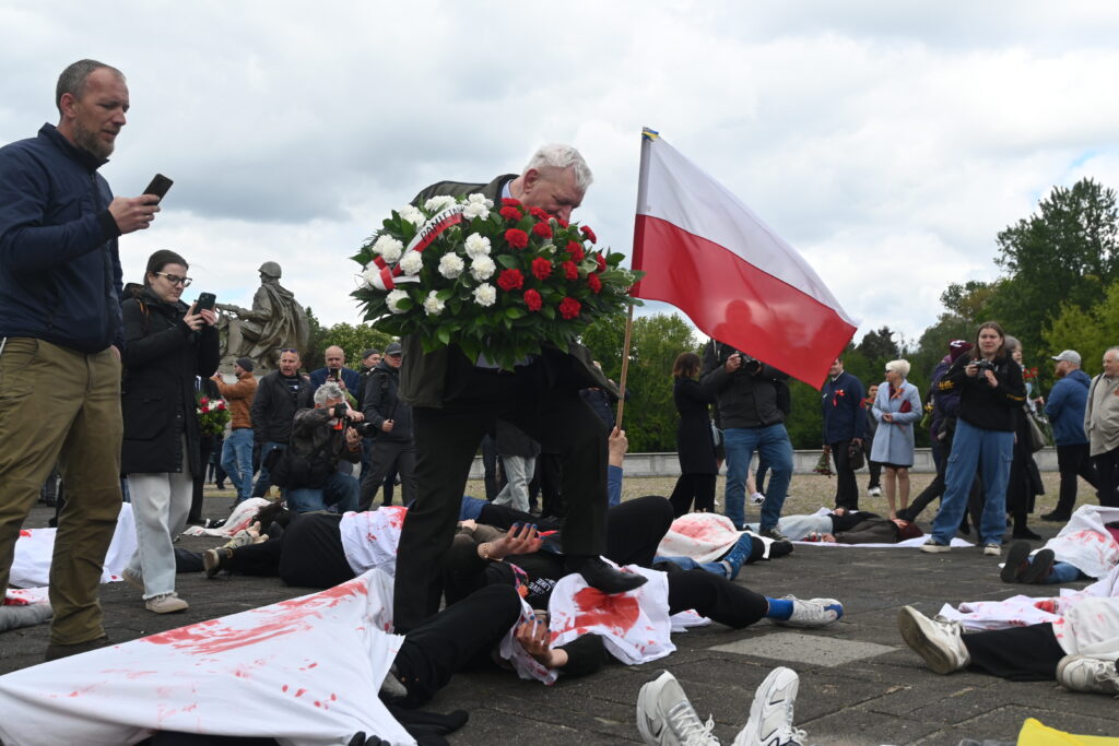 Russian ambassador walks over bodies of Ukrainians representing current war victims near monument to WWII Soviet soldiers