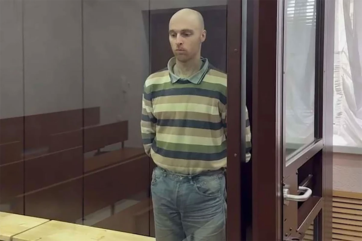 Australian national Oscar Jenkins stands in a glass cage after sentencing by a Russian kangaroo court in occupied Luhansk. Photo: "LNR" prosecutor’s office