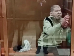 English teacher Stephen Hubbard is sitting in a defendants' glass box in the courtroom after he was captured by the Russians and sentenced to 7 years in prison for alleged mercenary work