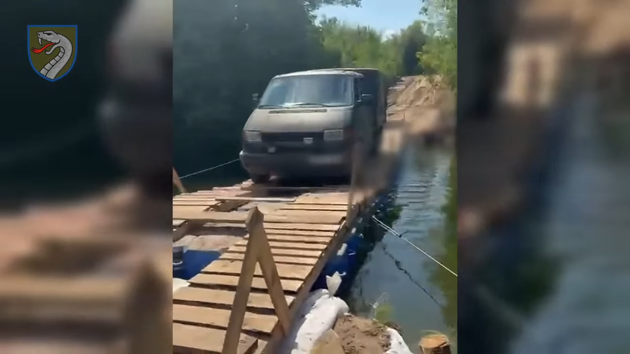 A van crosses the modular plastic bridge reinforced with wooden decking. Source: 61st Mechanized Brigade.