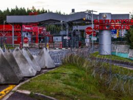 Concrete anti-tank barriers known as "dragon's teeth" are positioned at a Lithuania-Belarus border crossing point. The triangular obstacles are part of Lithuania's defensive measures to strengthen border security and restrict vehicle movement as part of the planned Baltic Defense Line.