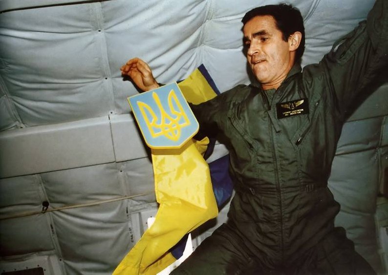 the flag and emblem of Ukraine in space.