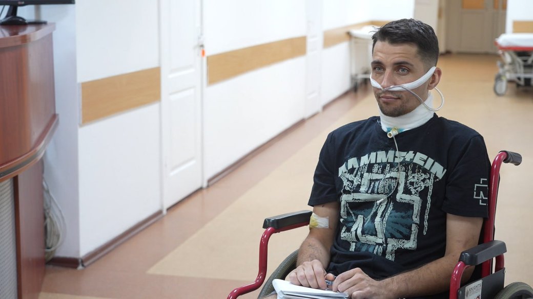 Ukrainian soldier Vladyslav sits in his wheelchair at the hospital, communicating through written notes after Russian forces cut his throat during torture and left him in a pit with corpses of other killed Ukrainian fighters, thinking he was dead. The 33-year-old National Guard soldier survived and crawled for five days to safety.