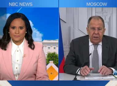 Split screen showing NBC News "Meet the Press" interview with interviewer Kristen Welker in NBC studio on left and Russian Foreign Minister Sergey Lavrov speaking from Moscow on right.