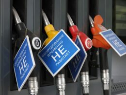 Gas station fuel pumps with blue signs displaying 'НЕТ' (NO) in Cyrillic text, indicating the pumps are out of service due to fuel unavailability.