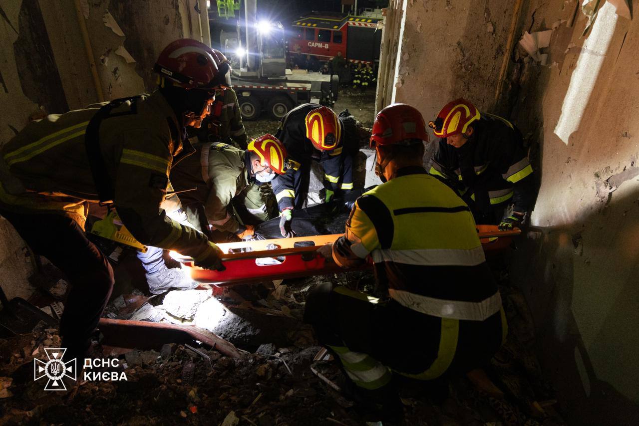 Emergency workers recover the body of a third victim from the rubble of a destroyed apartment building in Kyiv's Sviatoshynsky district following Russian attack on 7 September.
