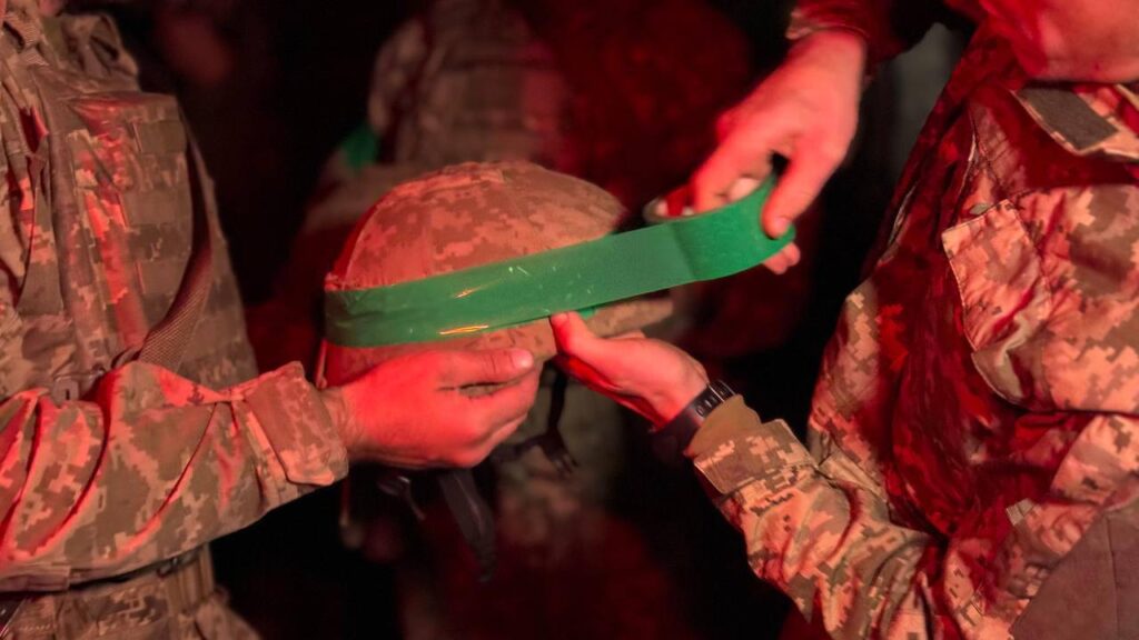 425th Assault Regiment troopers apply identification tape.
