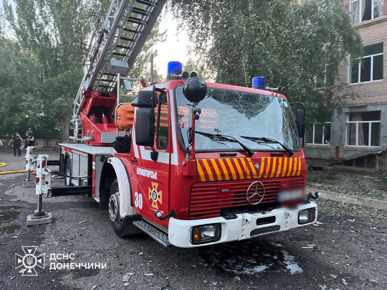 Fire truck in Kramatorsk with damage from debris, in the area struck by a second Russian drone while firefighters worked.