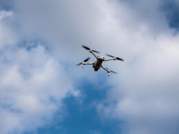 An illustrative image. Flying drone on the sky with clouds.