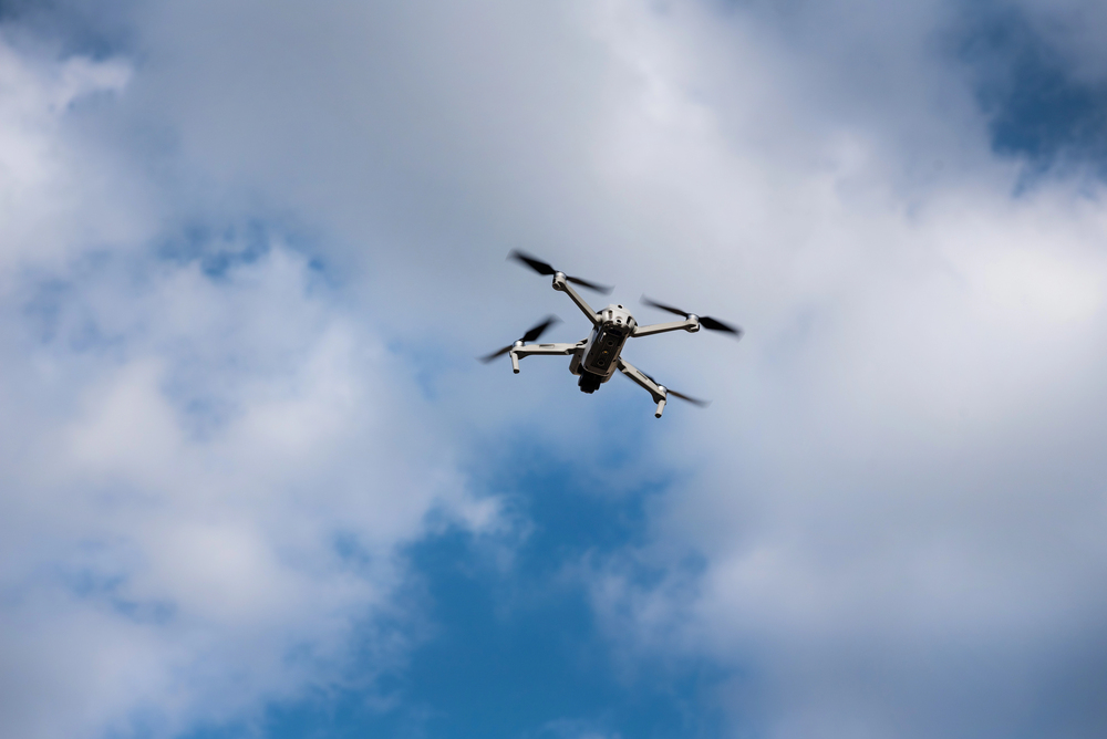 An illustrative image. Flying drone on the sky with clouds.