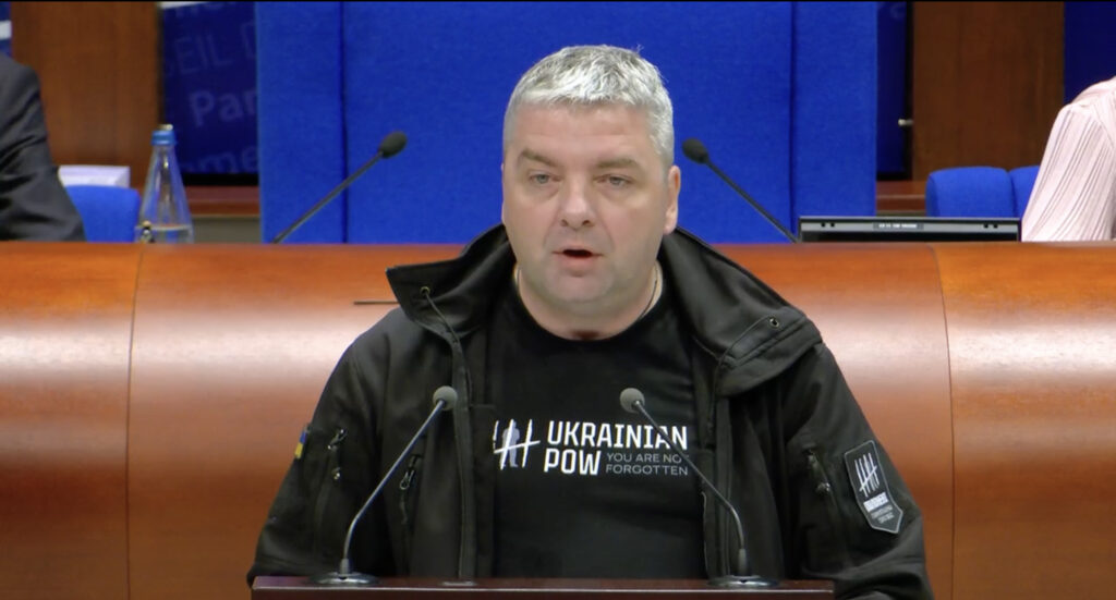 Maksym Butkevych delivers his acceptance speech at the Parliamentary Assembly of the Council of Europe in Strasbourg on 29 September, wearing a hoodie with the message "Ukrainian POW You Are Not Forgotten." The journalist and human rights defender became the first Ukrainian to receive the Václav Havel Human Rights Prize since its establishment in 2013. Photo: PACE
