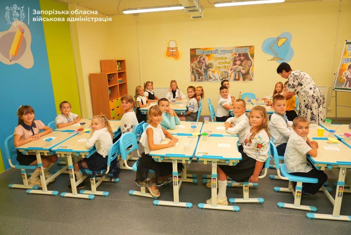 Children seated at desks inside an underground classroom in Zaporizhzhia, attending lessons in a secure school facility.