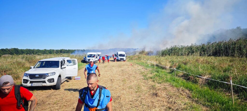 Rescue workers on scene after a Russian missile strike on a humanitarian demining mission in Chernihiv Oblast, Ukraine.