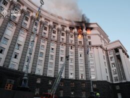 Partially destroyed government building in Kyiv after Russian missile and drone attack, with visible damage to roof and upper floors.
