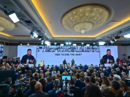 Ukrainian President Volodymyr Zelenskyy speaks before an audience.