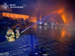 Firefighters spray water on burning buildings in Zaporizhzhia following overnight Russian strikes on 16 September.