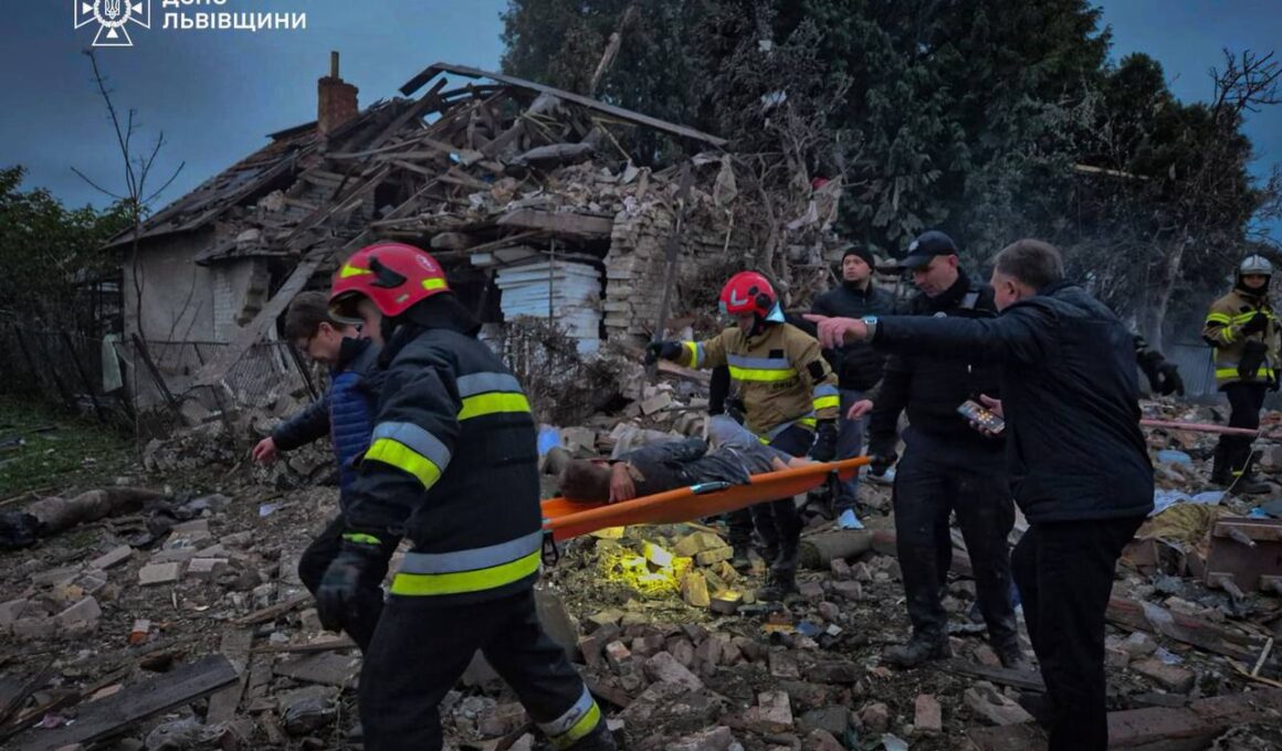 Emergency workers evacuate an injured person from a destroyed home in Lviv Oblast following the Russian attack on 5 October that killed a family of four, including a 15-year-old girl.