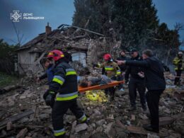 Emergency workers evacuate an injured person from a destroyed home in Lviv Oblast following the Russian attack on 5 October that killed a family of four, including a 15-year-old girl.