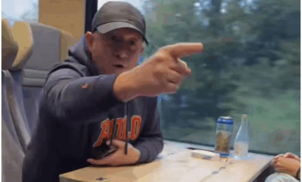 A screenshot from video shows Russian-speaking Latvian citizen Aleksandrs Vabiks gesturing aggressively at a Ukrainian family on a Swiss train after he heard them speaking Ukrainian, 13 October.