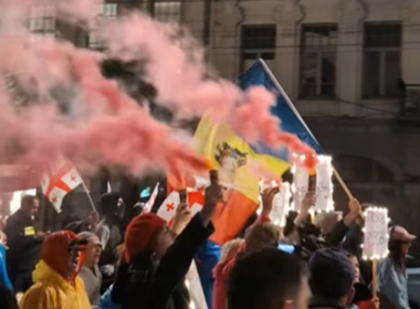 Protesters in Tbilisi hold Moldovan flag during the unrest in the result of the local elections