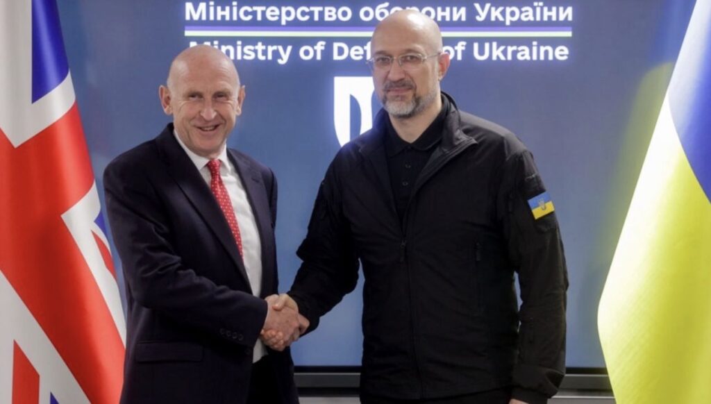 UK Defense Secretary John Healey shakes hands with Ukrainian Minister of Defense Denys Shmyhal in Kyiv during his fifth visit to discuss Britain’s military support for Ukraine, with UK and Ukrainian flags in the background