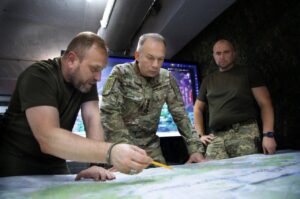 Commander-in-Chief of the Armed Forces of Ukraine, General Oleksandr Syrskyi (center), reviewing a military map with Ukrainian officers in Donetsk Oblast on 4 October 2025