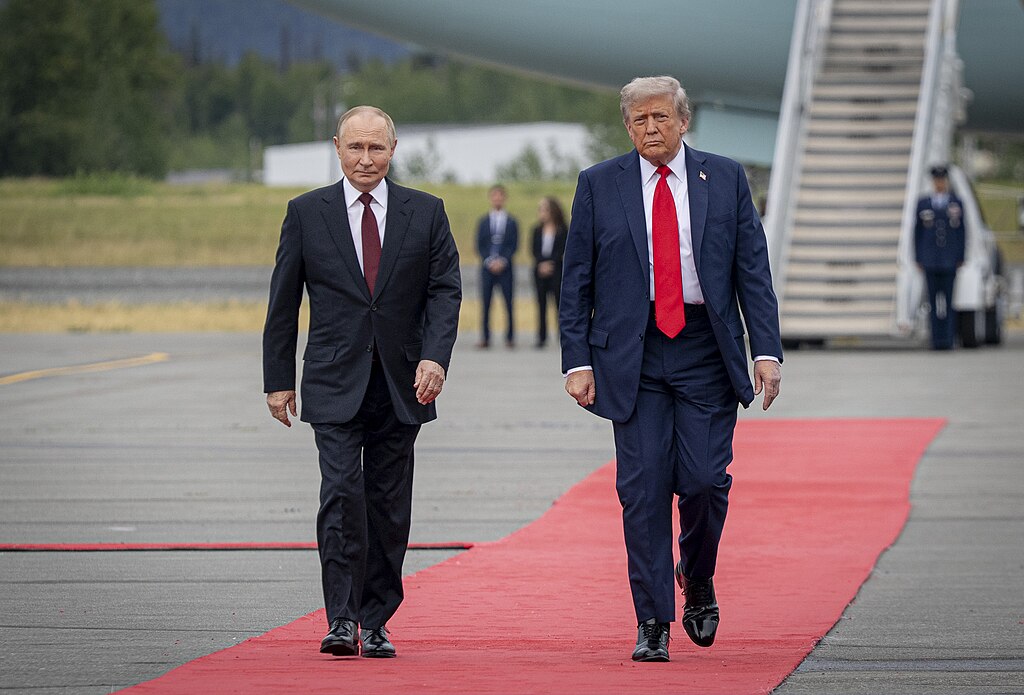 US President Donald Trump and Russian President Vladimir Putin walk side by side on a red carpet at Joint Base Elmendorf-Richardson, Anchorage, Alaska, on 15 August 2025, ahead of their bilateral meeting