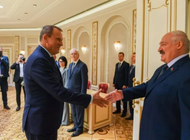Leningrad Oblast Governor Aleksandr Drozdenko shakes hands with Belarusian authoritarian leader Aleksandr Lukashenka in Minsk in 2024, during talks to expand rehabilitation programs for Russian war veterans at Belarusian sanatoriums.