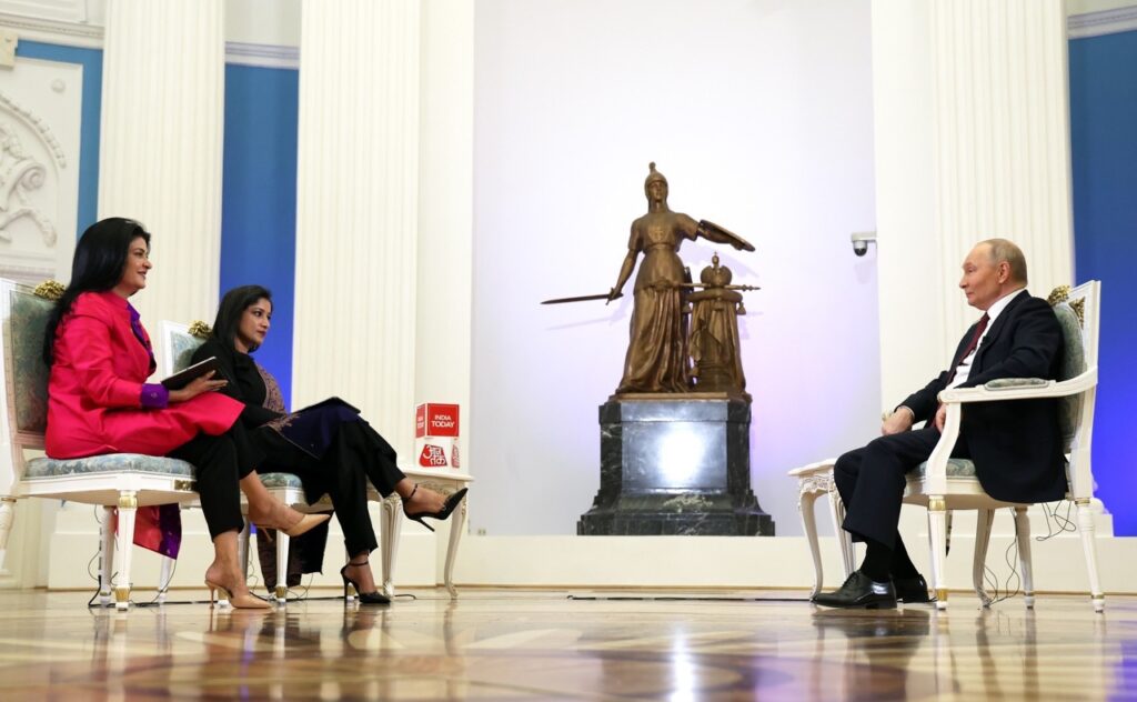 Putin sits across from two India Today journalists in an ornate Kremlin hall with white columns and a bronze statue, December 2025