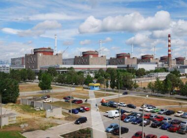 Zaporizhzhia Nuclear Power Plant with three reactor units visible, parking lot in foreground