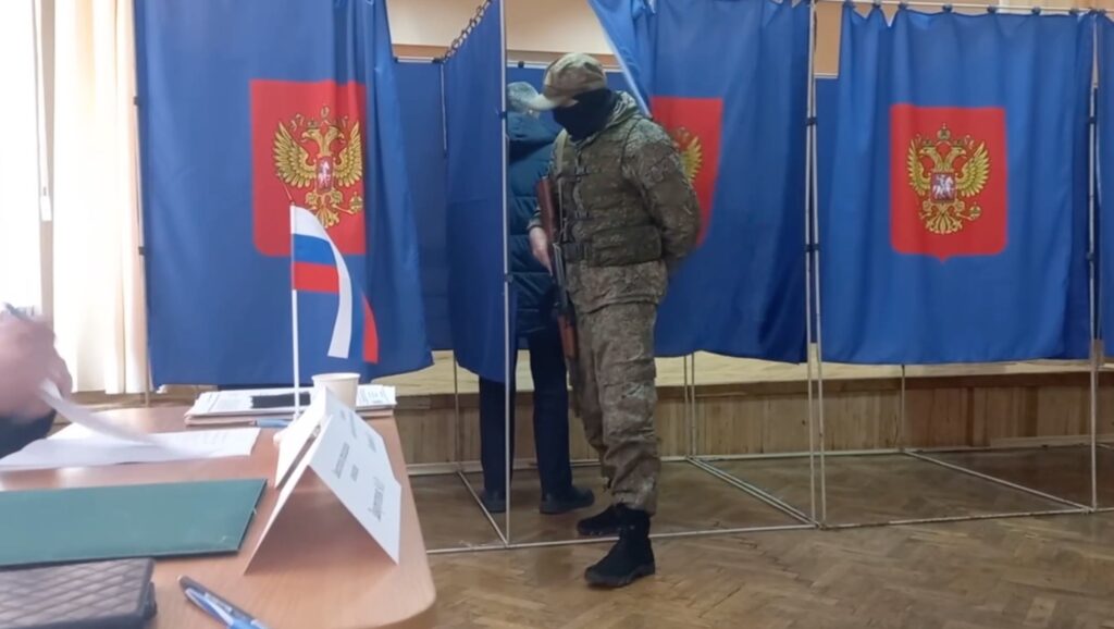 A Russian soldier guards a voting station during Moscow's staged referendum in occupied Ukraine