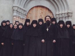 Archpriest Andrey Lemeshonok stands with nuns from St. Elisabeth Convent in Belarus outside a church entrance. Sweden has warned parishes against hosting the convent's fundraising operations.